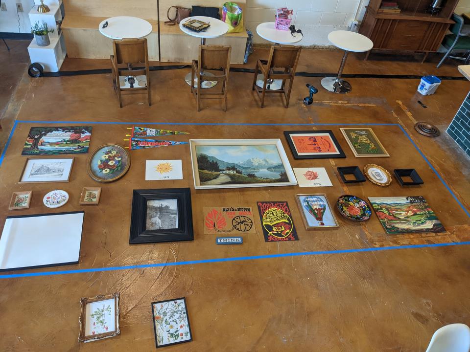 Artwork laid out on a wooden floor