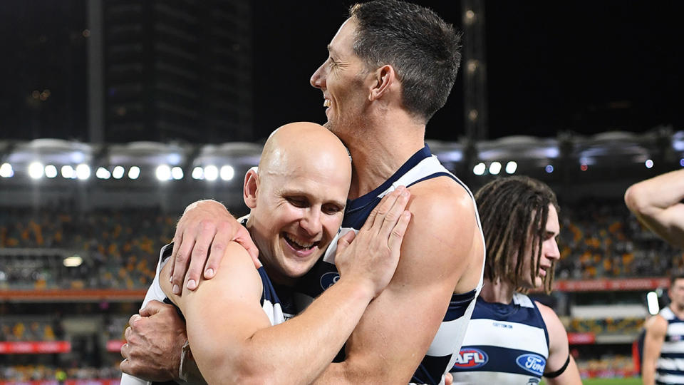 Geelong stalwarts Gary Ablett Jr and Harry Taylor are pictured embracing after the 2020 AFL grand final.