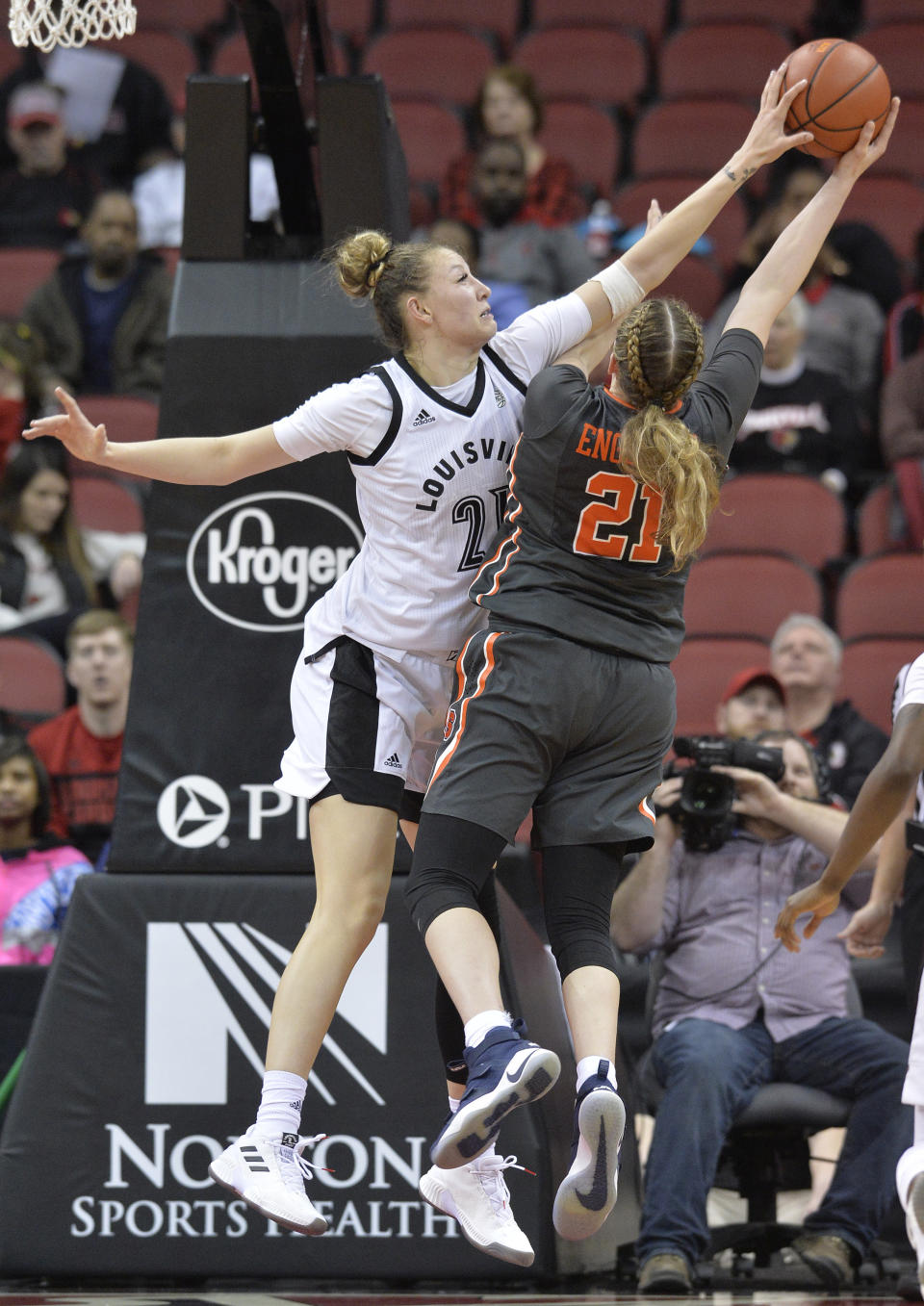 Louisville forward Kylee Shook (21) blocks the shot of Syracuse guard Emily Engstler (21) during the second half of an NCAA college basketball game in Louisville, Ky., Thursday, Feb. 7, 2019.  (AP Photo/Timothy D. Easley)