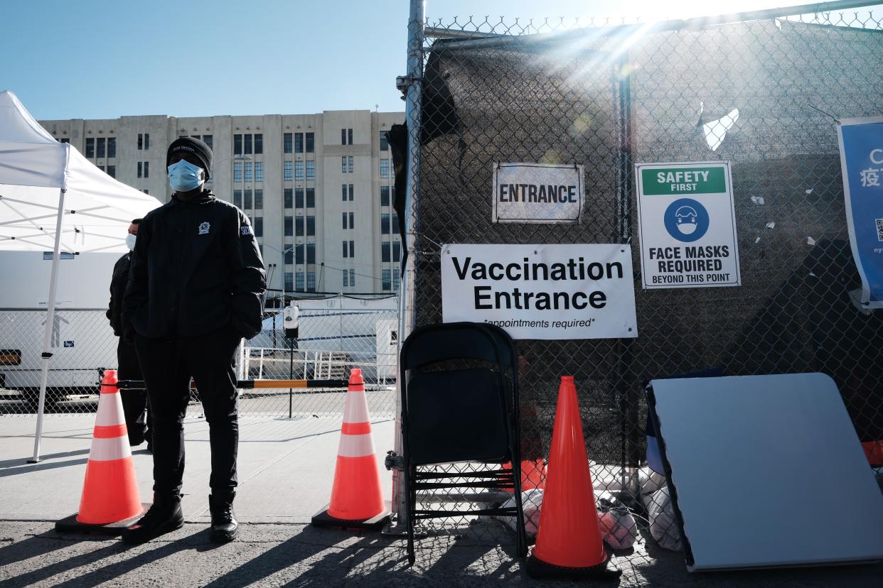 A guard stands in front of a COVID-19 vaccination location on March 29, 2021, in the Brooklyn borough of New York City. As New York’s positivity rate slowly climbs, Governor Andrew Cuomo has announced that New Yorkers 30 years of age and older will be vaccine-eligible starting Tuesday.
