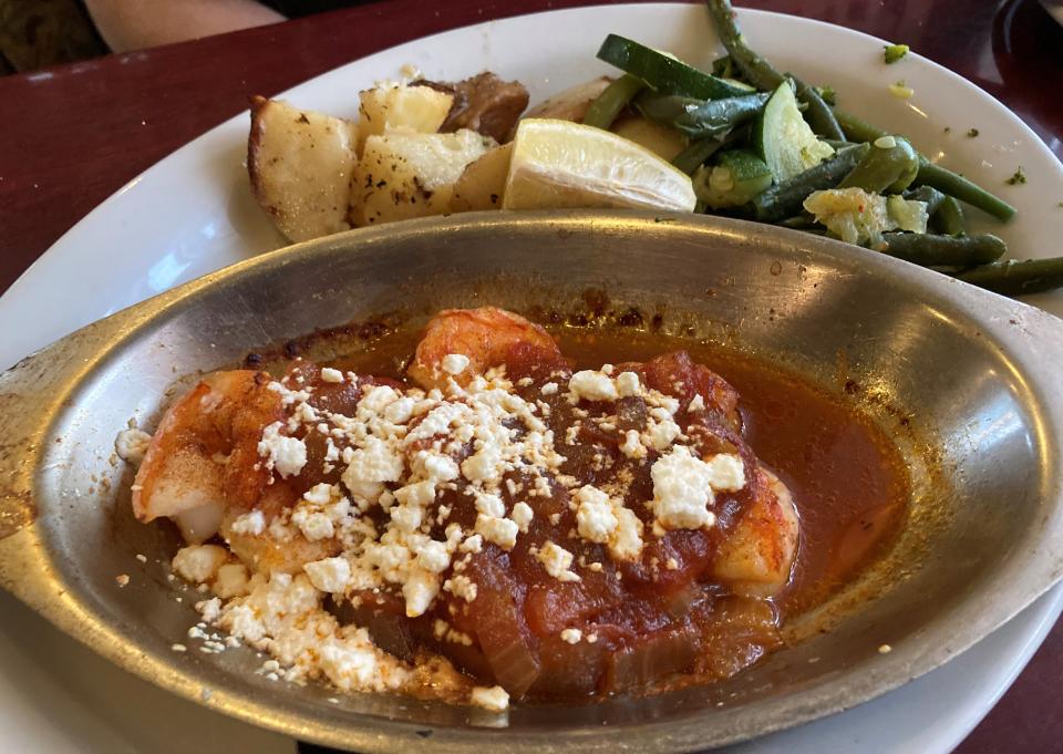 Shrimp & Scallops Mykonos, baked in caramelized onion and tomato sauce with melted feta cheese, at Olympia Restaurant, 5629 Oleander Dr. in Wilmington, N.C.