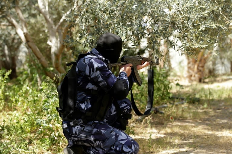 A Hamas policeman takes position in Nuseirat, south of Gaza City, on March 22, 2018, as security forces carry out a raid that resulted in the arrest of a suspect in a recent bomb attack against the Palestinian prime minister