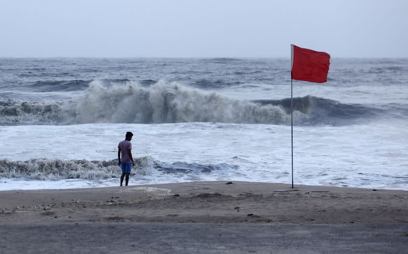 A lifeguard patrols Juhu beach during a red flag alert due to rough seas caused by cyclone Biparjoy, in Mumbai