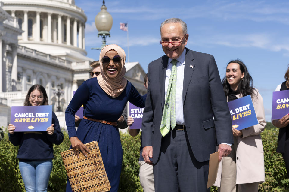FILE - Senate Majority Leader Chuck Schumer, D-N.Y., and Rep. Ilhan Omar, D-Minn., react during a news conference on student debt cancellation on Capitol Hill in Washington, Sept. 29, 2022. ( AP Photo/Jose Luis Magana, File)