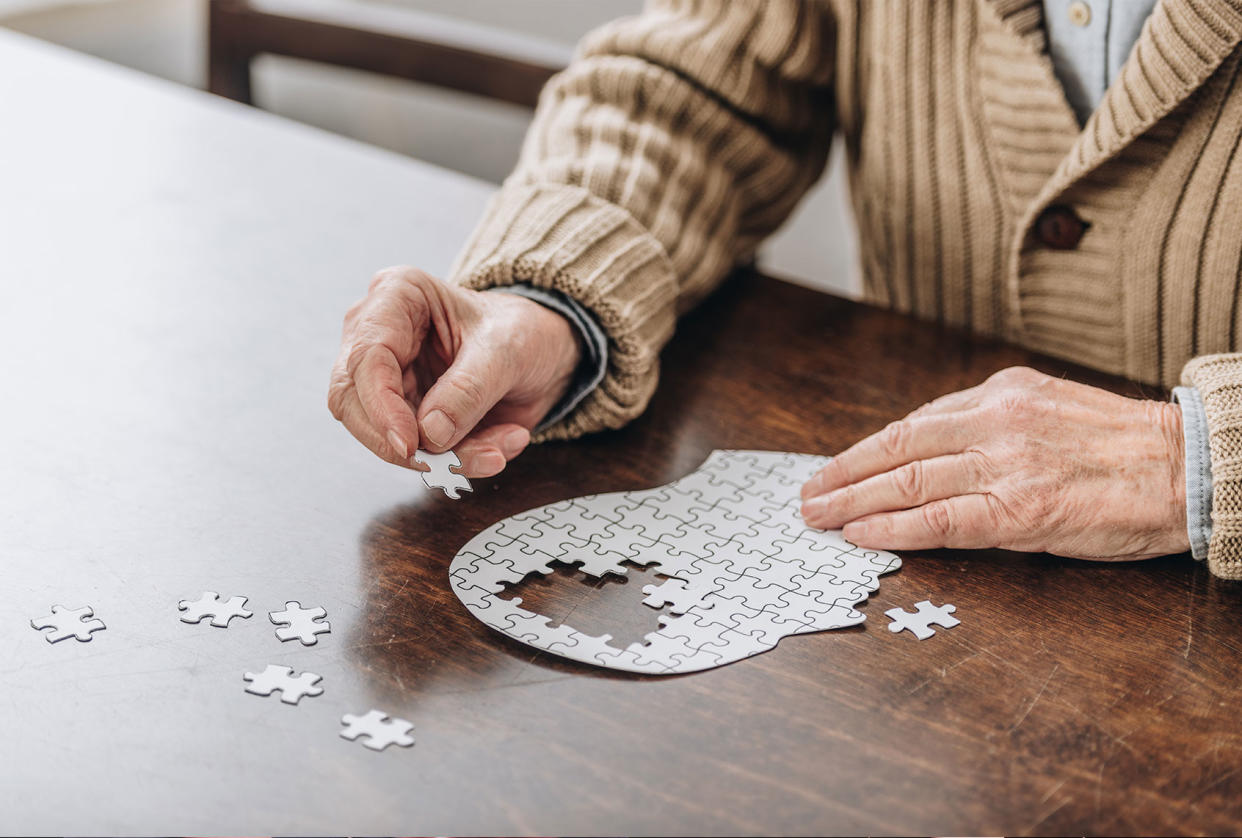 Senior man playing with puzzle Getty Images/LightFieldStudios