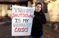 Cher Muzyk, wife of a government attorney impacted by the shutdown, holds the sign she carried at yesterdays DC "Rally to End the Shutdown" at her home in Nokesville, Virginia, U.S., January 11, 2019. REUTERS/Kevin Lamarque