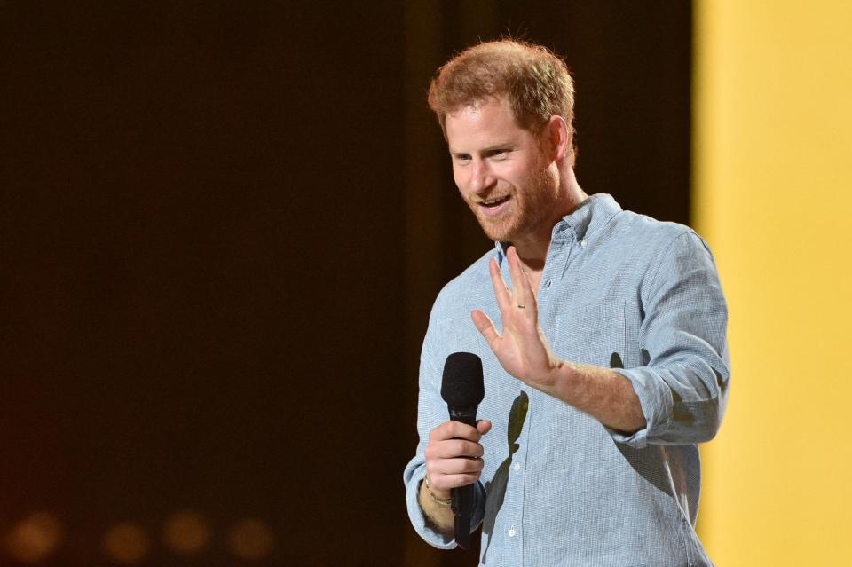 Co-Chair Britain's Prince Harry, Duke of Sussex, waves as he speaks onstage to speak during the taping of the "Vax Live" fundraising concert at SoFi Stadium in Inglewood, California, on May 2, 2021. - The fundraising concert "Vax Live: The Concert To Reunite The World", put on by international advocacy organization Global Citizen, is pushing businesses to "donate dollars for doses," and for G7 governments to share excess vaccines. The concert will be pre-taped on May 2 in Los Angeles, and will stream on YouTube along with American television networks ABC and CBS on May 8. (Photo by VALERIE MACON / AFP) (Photo by VALERIE MACON/AFP via Getty Images) ORG XMIT: 0 ORIG FILE ID: AFP_9986GT.jpg