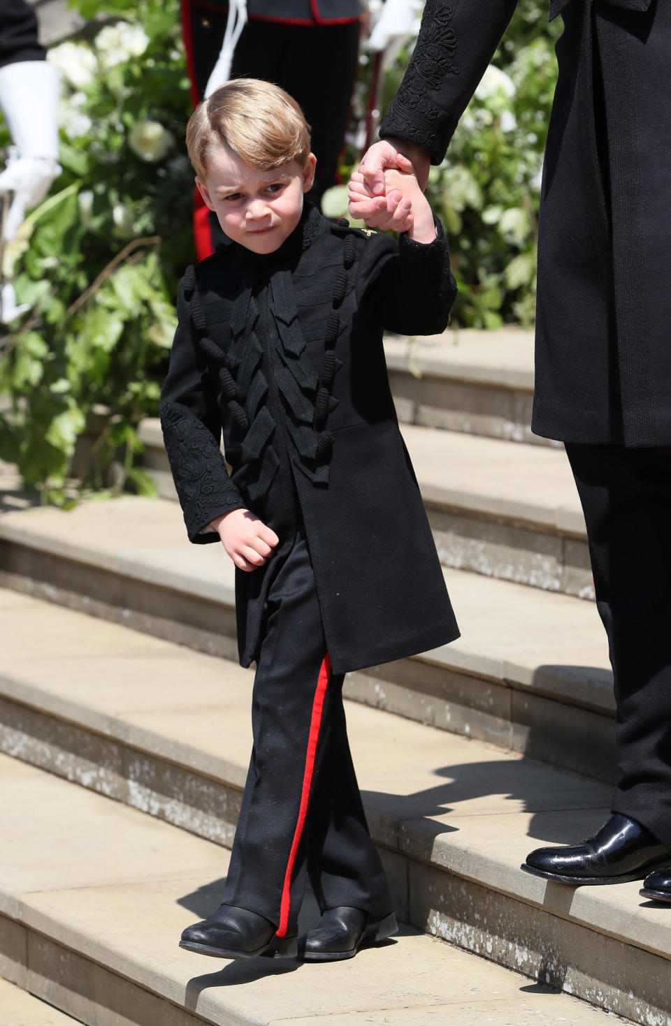 Prince George leaves St George's Chapel at Windsor Castle after the wedding of Prince Harry, Duke of Sussex and Meghan Markle on May 19, 2018, in Windsor, England.