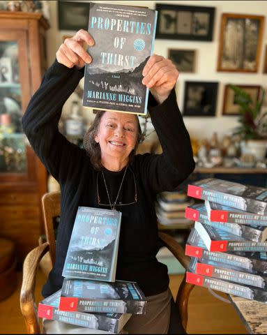 <p>Lara Porzak</p> Wiggins holding up her newly published book, 2022