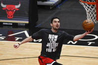 Chicago Bulls guard Tomas Satoransky warms up wearing a shirt that honors Dr. Martin Luther King Jr., before an NBA basketball game against the Houston Rockets, Monday, Jan. 18, 2021, in Chicago. (AP Photo/Matt Marton)