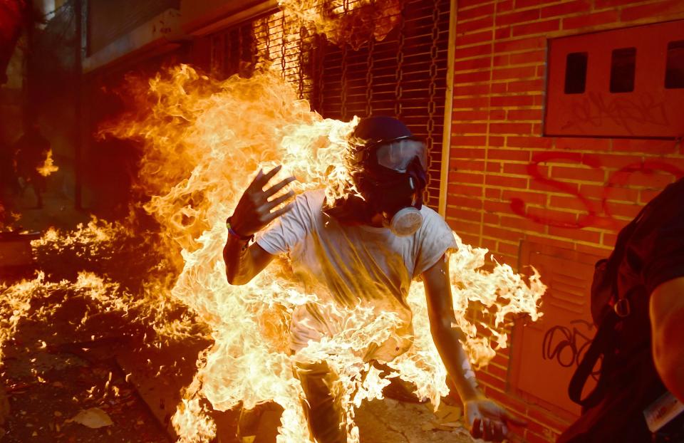 A demonstrator catches fire during clashes with riot police on May 3, 2017. Protests against the government of beleaguered leftist President Nicolas Maduro have wracked Venezuela for months.