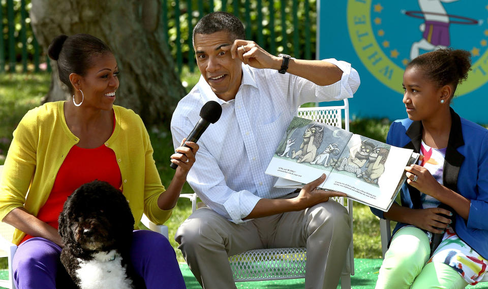 Obama acts out a part of the story while reading from the book <i>Where The Wild Things Are</i>&nbsp;with first lady Michelle Obama (L) and his daughter Sasha (R) during the White House Easter Egg Roll on the South Lawn of the White House on April 9, 2012, in Washington, D.C.