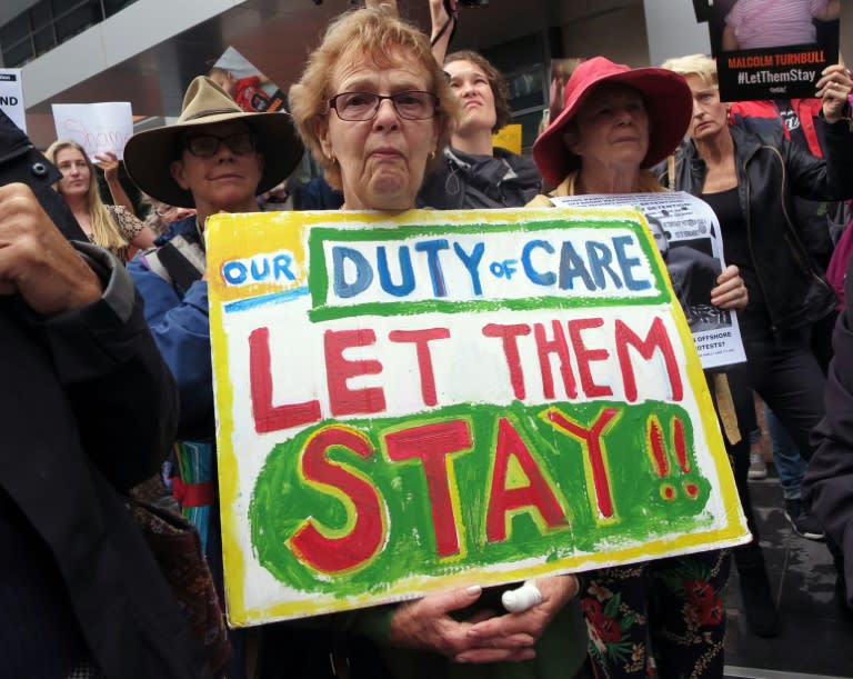 People protest outside an immigration office in Sydney