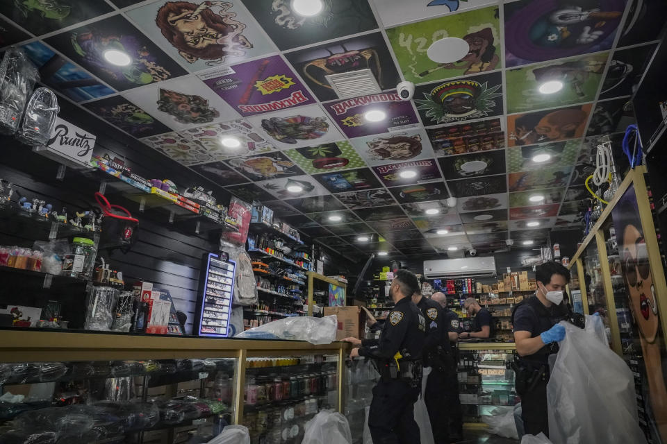 Law enforcement members of New York Sheriff's Joint Compliance Task Force (SJCTF) confiscate and bag illegal vaping products, during raid of a tobacco shop, Wednesday Sept. 27, 2023, in New York. Communities across the U.S. are confronting a new vaping problem: how to get rid of millions of disposable e-cigarettes that are considered hazardous waste. The devices contain nicotine, lithium and other materials that cannot be reused or recycled. (AP Photo/Bebeto Matthews)