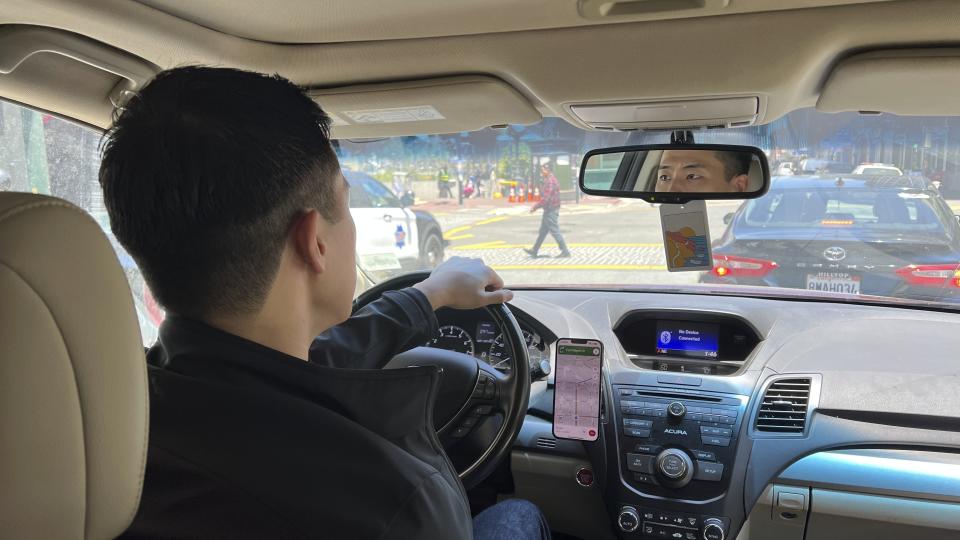 Andy Fang, DoorDash’s co-founder and chief technology officer, picks up and delivers food orders to customers in downtown San Francisco on Saturday, June 15, 2023. Fang is one of a growing number of executives who work shifts on the front lines of the companies they run. All DoorDash salaried employees are required to make deliveries or work directly with customers or merchants several times a year. (AP Photo/Terry Chea)