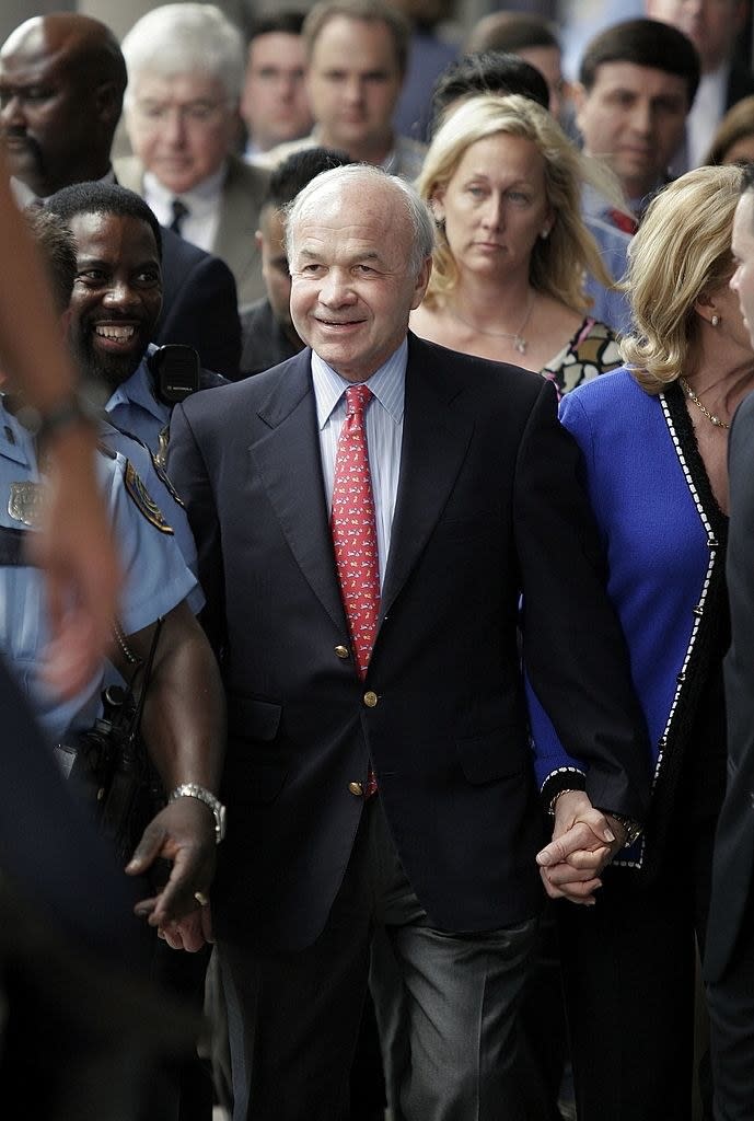 Kenneth Lay walking hand in hand with others