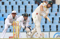 Australia's batsman Alex Doolan, right, plays a stroke shot as South Africa's wicketkeeper AB de Villiers, center, and captain Graeme Smith, left, watch on the third day of their their cricket test match at Centurion Park in Pretoria, South Africa, Friday, Feb. 14, 2014. (AP Photo/ Themba Hadebe)