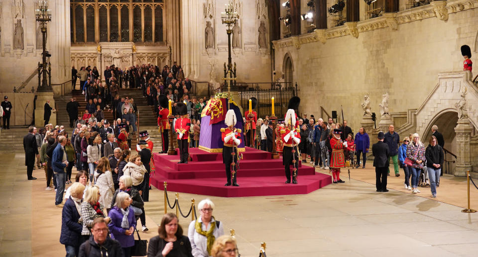 Members of the public file past the coffin of Queen Elizabeth II lying in state.