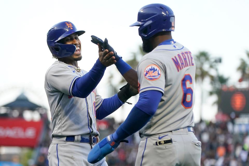 New York Mets' Francisco Lindor, left, celebrates with Starling Marte after both scored on a three-run home run hit by Pete Alonso during the third inning of a baseball game against the San Francisco Giants in San Francisco, Monday, May 23, 2022.