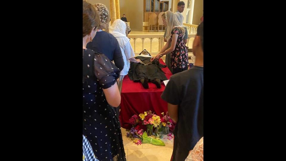 Catholics line up to pray beside the body of Sister Wilhelmina Lancaster.