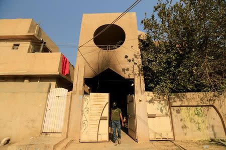 A member of Iraqi security forces inspects a building that was used as a prison by Islamic State militants in Hammam al-Ali, south of Mosul, during an operation to attack Islamic State militants in Mosul, Iraq November 7, 2016. REUTERS/Thaier Al-Sudani