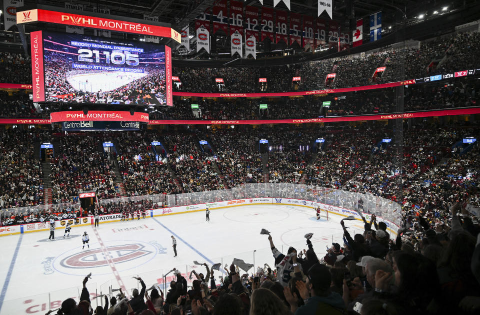 Fans cheer on as the attendance number is displayed on the big screen during the third period of a PWHL hockey game between Toronto and Montreal at the Bell Centre in Montreal, Saturday, April 20, 2024.(Graham Hughes/The Canadian Press via AP)