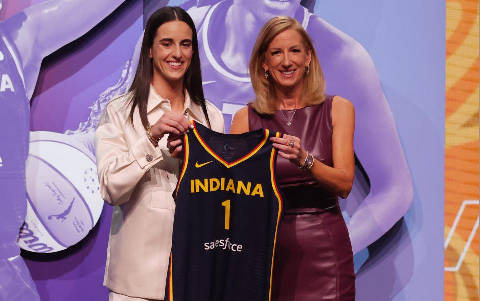 Caitlin Clark poses with WNBA commissioner Cathy Engelbert after she is selected with the number one overall pick to the Indiana Fever