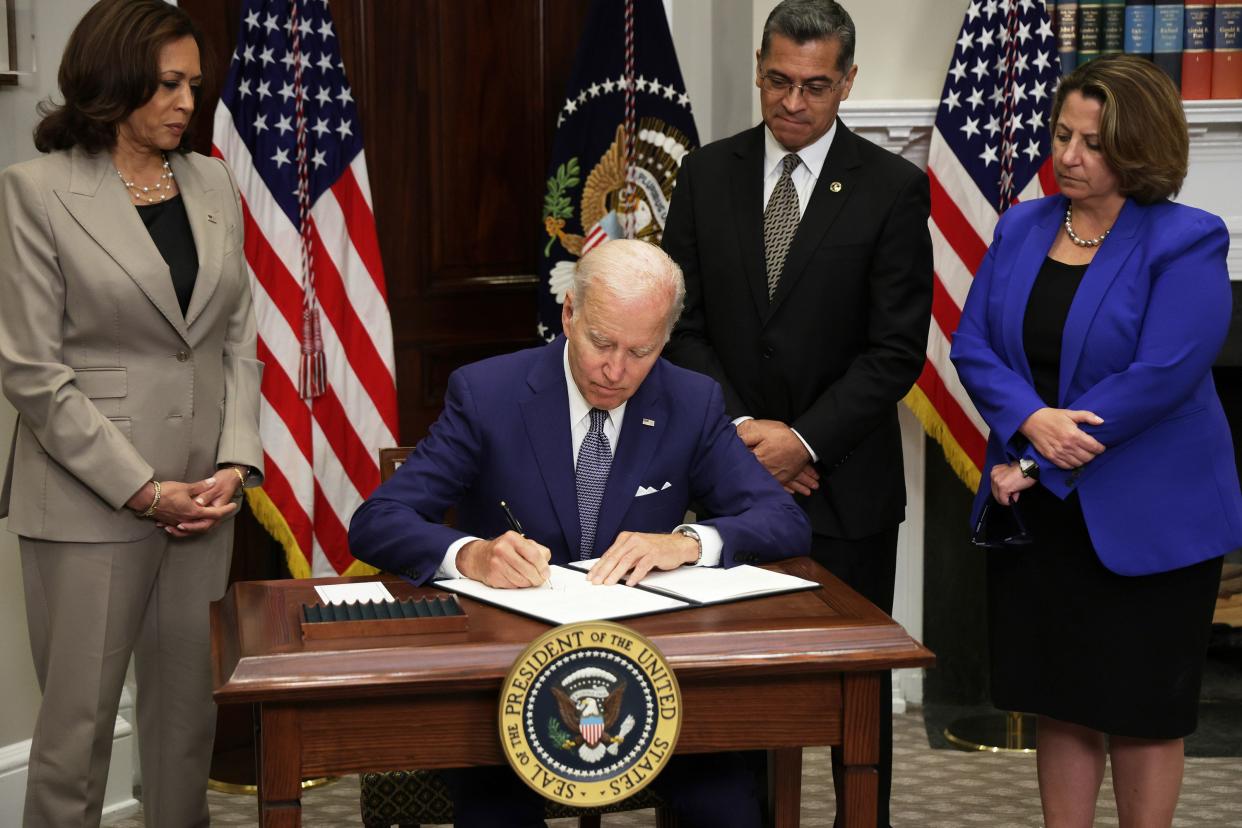 U.S. President Joe Biden signs an executive order on access to reproductive health care services as (L-R) Vice President Kamala Harris, Secretary of Health and Human Services Xavier Becerra, and Deputy Attorney General Lisa Monaco look on during an event at the Roosevelt Room of the White House on July 8, 2022, in Washington, DC. President Biden delivered remarks on reproductive rights at the event.