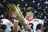 Georgia's Stetson Bennett celebrates after the College Football Playoff championship football game against Alabama Tuesday, Jan. 11, 2022, in Indianapolis. Georgia won 33-18. (AP Photo/Darron Cummings)