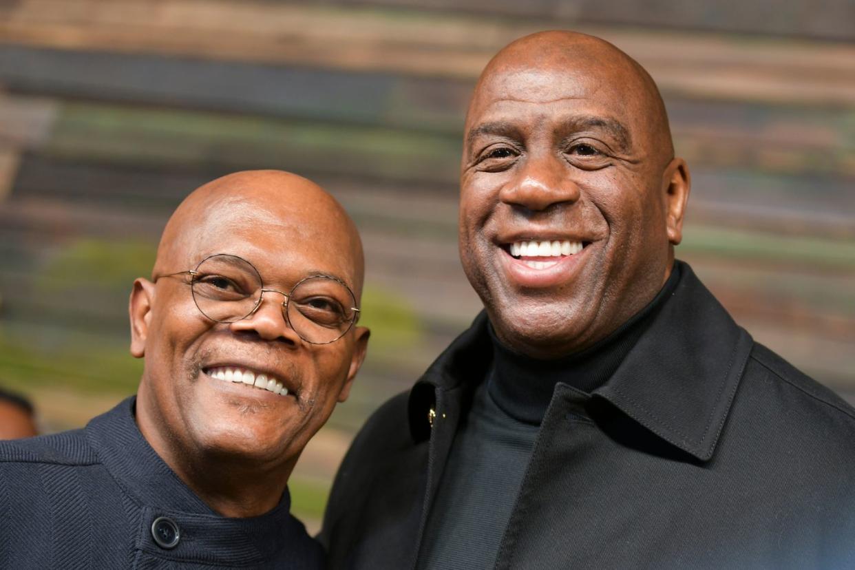 Samuel L Jackson and Magic Johnson posing for picture together