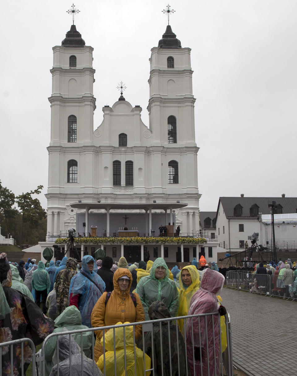 Faitfhul wait in the rain for Pope Francis to arrive to celebrate a Holy Mass in the Shrine of the Mother of God, in Aglona, Latvia, Monday, Sept. 24, 2018. Francis is visiting Lithuania, Latvia and Estonia to mark their 100th anniversaries of independence and to encourage the faith in the Baltics, which saw five decades of Soviet-imposed religious repression and state-sponsored atheism. (AP Photo/Mindaugas Kulbis)
