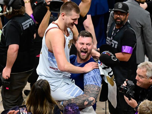 <p>Andy Cross/MediaNews Group/The Denver Post/Getty</p> Nikola Jokic (15) of the Denver Nuggets celebrates the NBA championship with his brother Strahinja after defeating the Miami Heat 94-89 in 2023