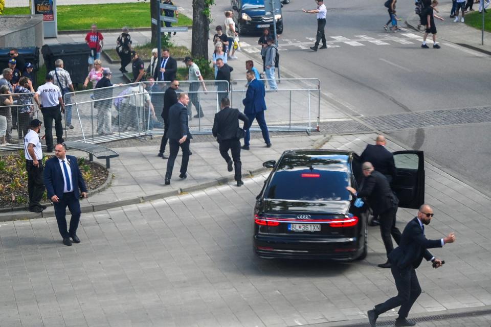 Robert Fico’s security team bundled him into a car after he was shot (Reuters)