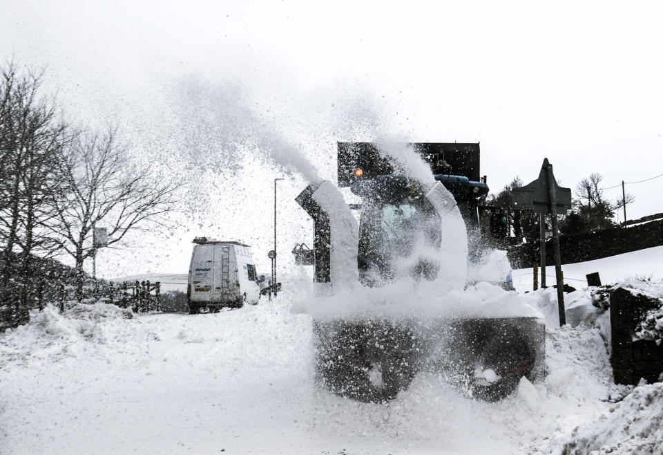 Snow is cleared from a road in Hayfield in Derbyshire as the wintry snap dubbed the "mini beast from the east" keeps its grip on the UK.