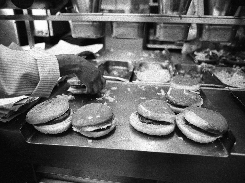 An employee makes burgers at a Burger King restaurant in 1982