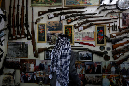 Youssef Akkar, 80, an Iraqi retired teacher looks at the old rare antiques and weapons hanged on the wall in his museum at home in Najaf, Iraq February 18, 2019. REUTERS/Alaa al-Marjani