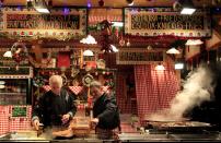 Vendors prepare food at the Budapest Christmas Fair at Vorosmarty square in downtown Budapest, December 11, 2013. REUTERS/Bernadett Szabo (HUNGARY - Tags: SOCIETY TRAVEL)