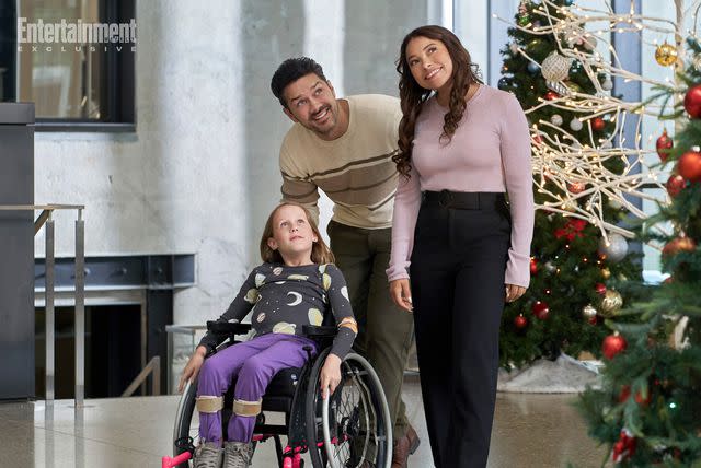 2023 Hallmark Media/Photographer: Steven Ackerman Emmy Richardson, Ryan Paevey, Jessica Parker Kennedy in 'Under the Christmas Sky'