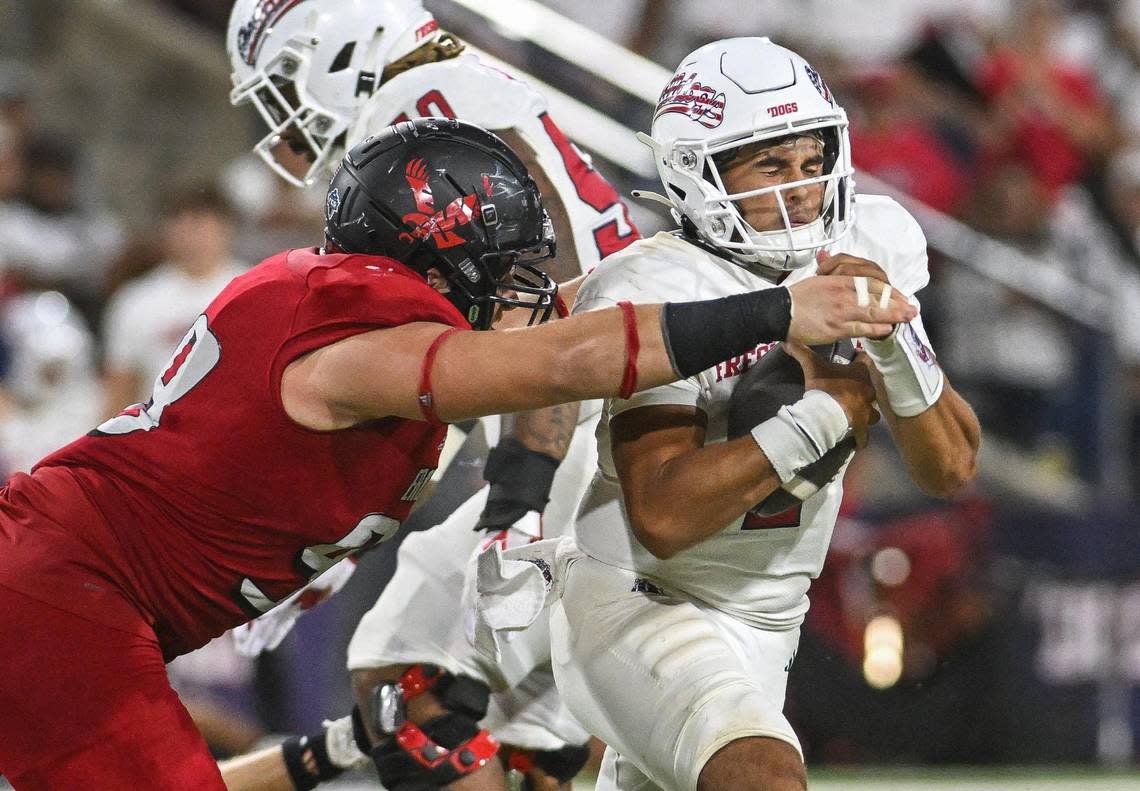 Fresno State quarterback Mikey Keene gets taken down for a sack by Eastern Washington’s Jacob Newsom in the second half of their game at Valley Children’s Stadium on Saturday, Sept. 9, 2023.