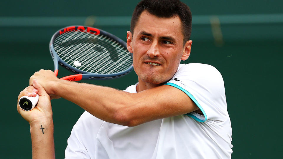 Bernard Tomic in action during the first round at Wimbledon. (Photo by Clive Brunskill/Getty Images)