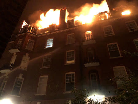 Firefighters tackle a blaze in a block of flats on fire in West Hampstead, London, England, July 26, 2018 in this picture obtained from social media. Matt Alis/via REUTERS