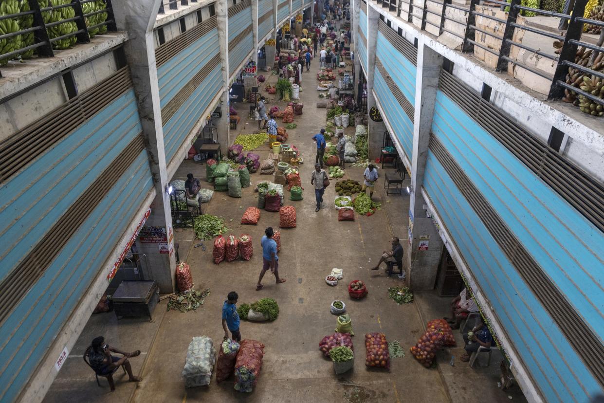 A view from above of a food market along a long street.