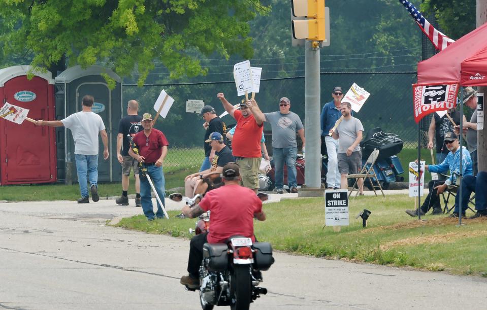 Members of the United Electrical, Radio and Machine Workers of America walk a picket line at the Wabtec Corp. East Lake Road gate on June 28, 2023. Nearly 1,400 union workers from UE locals 506 and 618 are on strike.