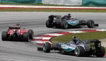 Formula One - F1 - Malaysian Grand Prix 2015 - Sepang International Circuit, Kuala Lumpur, Malaysia - 29/3/15 Mercedes' Lewis Hamilton (top) followed by Ferrari's Sebastian Vettel and Mercedes' Nico Rosberg in action during the race Reuters / Olivia Harris Livepic