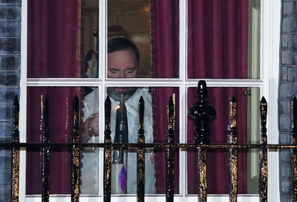 A candle being lit in the window of 10 Downing Street (PA)