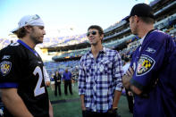 Olympic swimmer Michael Phelps talks with (L) Mark Reynolds and J.J. Hardy of the Baltimore Orioles on the field before the Baltimore Ravens take on the Cincinnati Bengals at M&T Bank Stadium on September 10, 2012 in Baltimore, Maryland. (Photo by Patrick Smith/Getty Images)