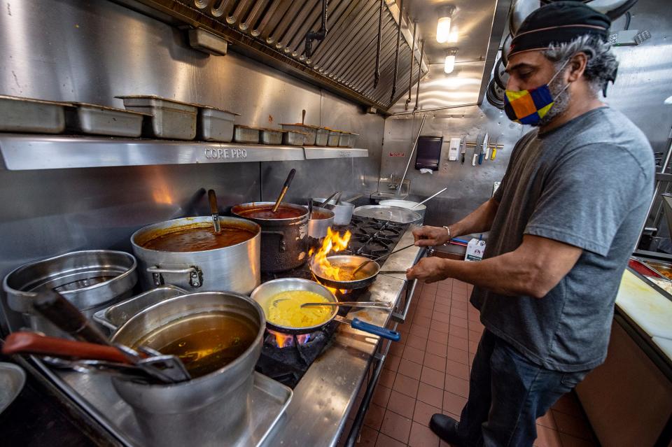 Guru's Fine Indian Cuisine in Newtown, owner/chef, Ashni Kumar Guru, preparing lobster bisque, and spicy coconut shrimp, Wednesday, Nov. 11, 2020.