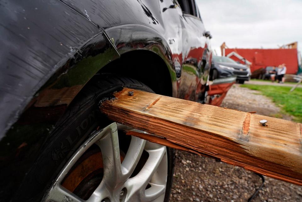 A piece of wood remains in a tire at Dietz Farm in Williamston after a tornado came through the previous night on Friday, August 25, 2023, that damaged the home for the farm including a 190-year-old barn but no one was injured.
