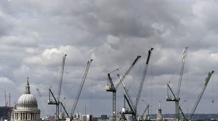 Construction cranes are seen around St. Paul's Cathedral in London, Britain, September 3, 2015. REUTERS/Toby Melville/File Photo