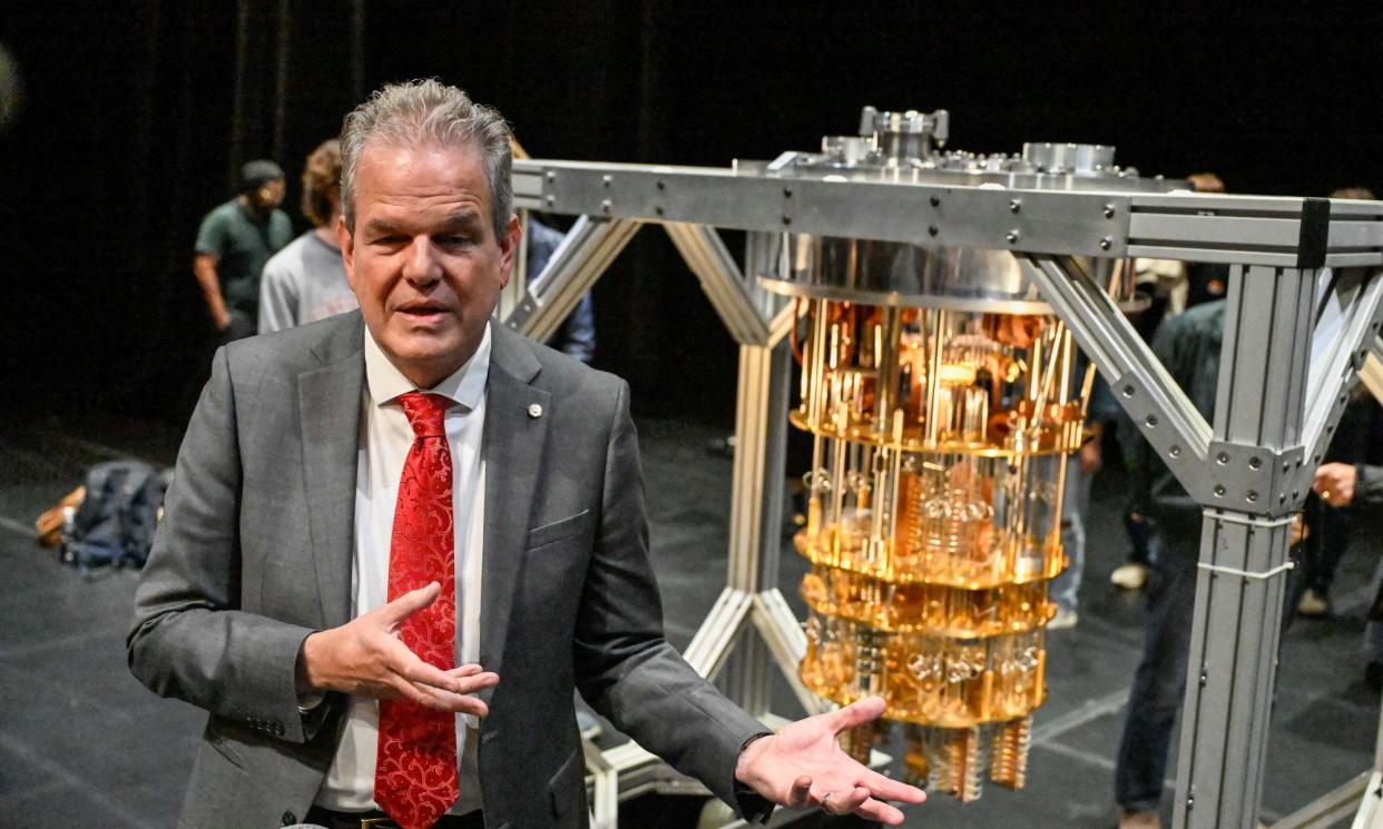 <span>Curtis Priem stands in front of the ‘quantum chandelier’, named for its interior gold lattices that suspend, cool and isolate its processor.</span><span>Photograph: Hans Pennink/AP Images for Rensselaer Polytechnic Institute</span>